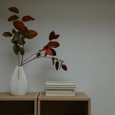 A neat stack of yoga mats in a calm, organized room.